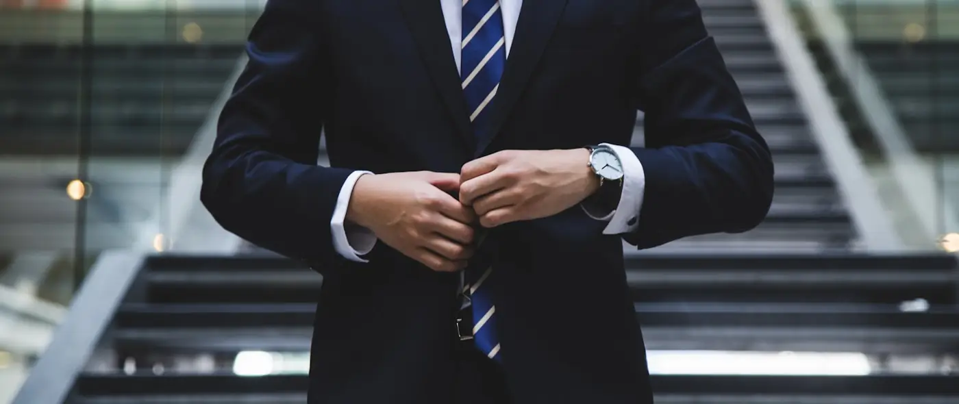 Professional in a suit reviewing documents at a desk