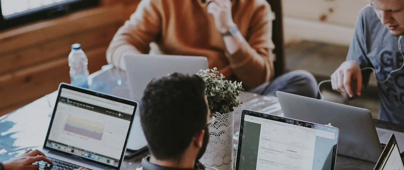 Two colleagues talking across a table in a bright office