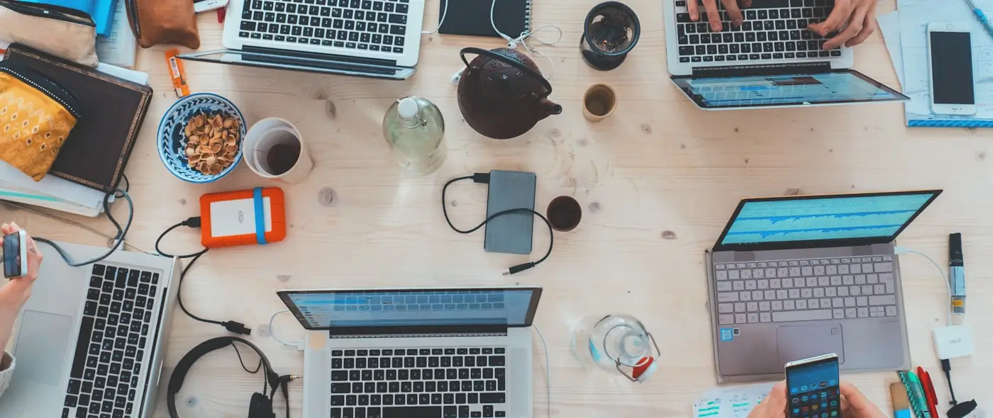 People collaborating at laptops in a modern tech workspace