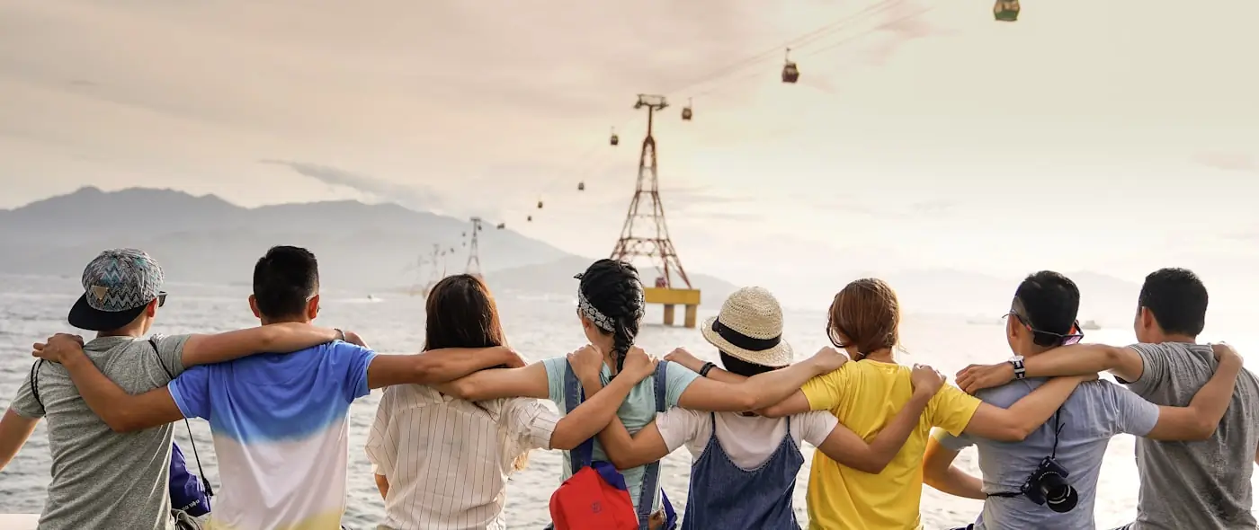 Group of people talking together outdoors in casual clothing