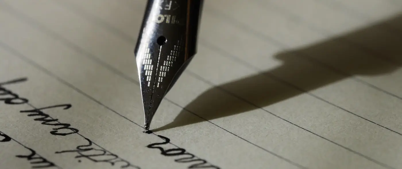 Person typing on a vintage typewriter representing structured writing