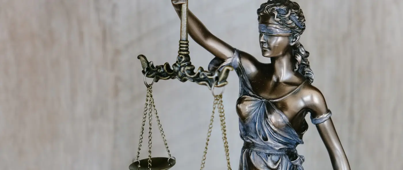 Legal scales and gavel on a desk symbolizing law and compliance