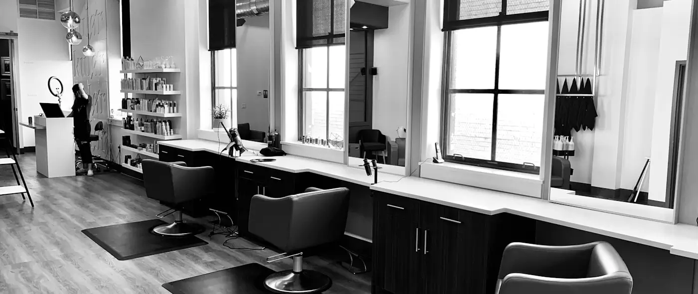 Hair stylist working with a client in a salon