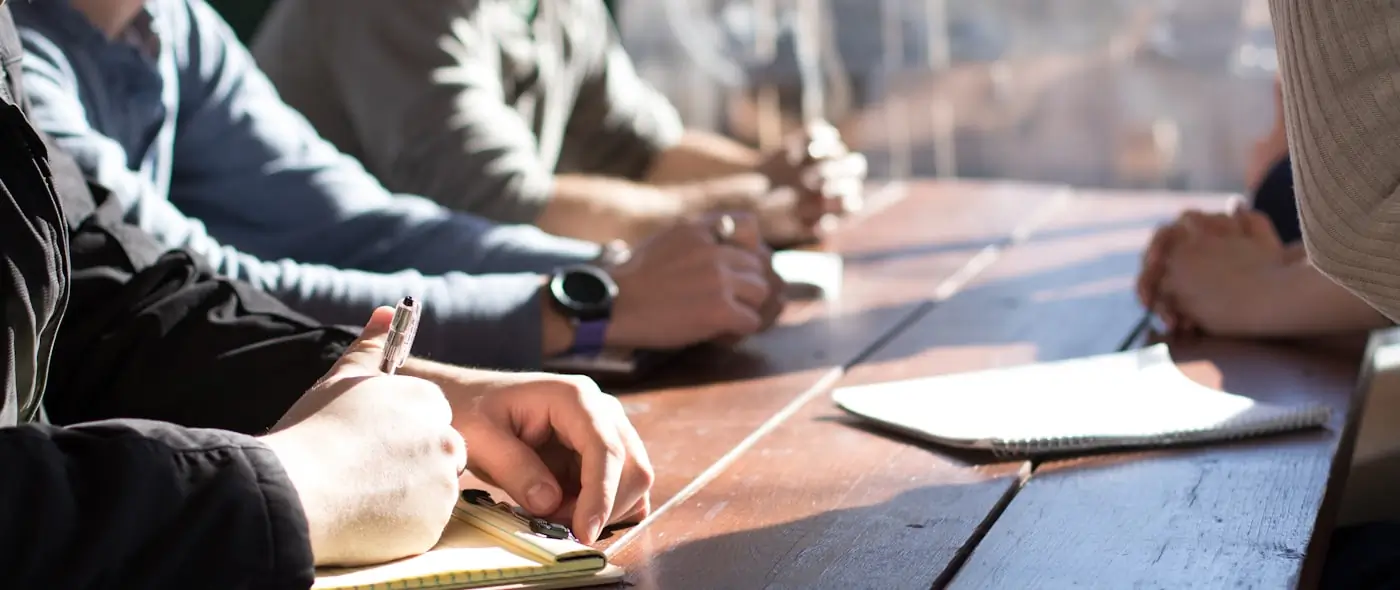 Team of professionals collaborating around a table in a bright office