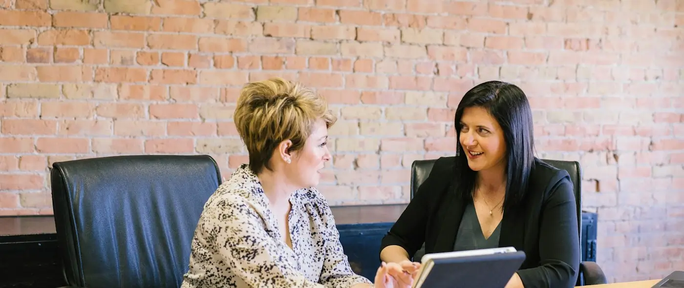 Two colleagues in conversation, seated across from each other