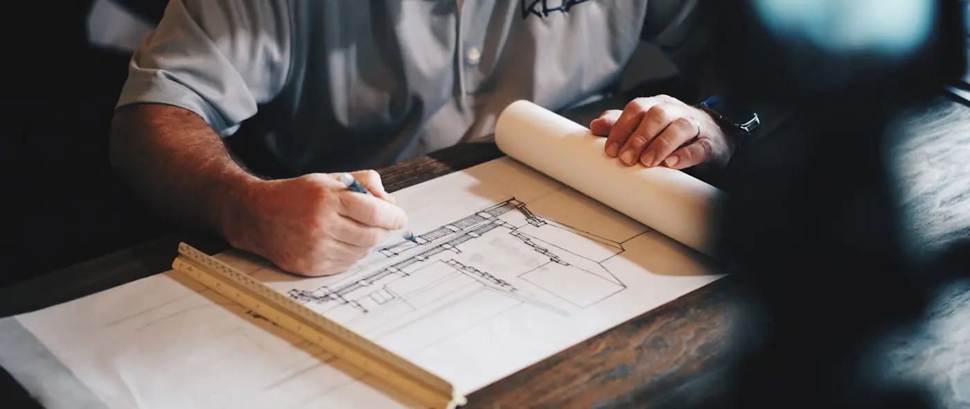 Construction workers reviewing plans at a building site