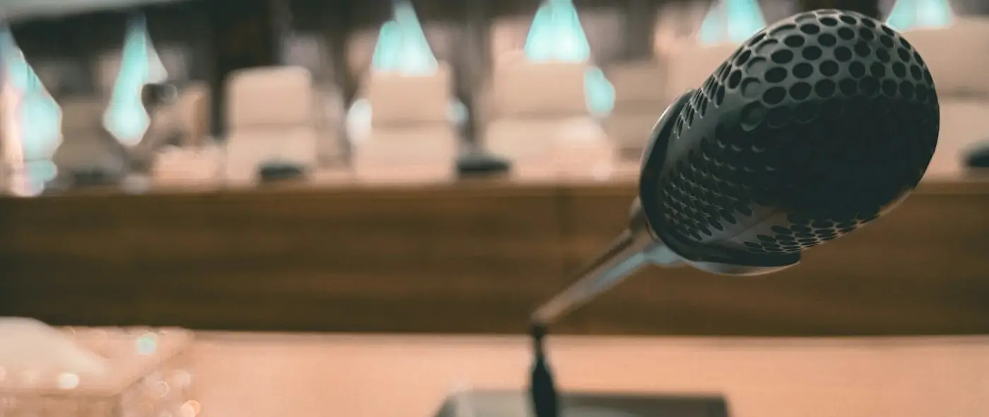 Close-up of a conference room microphone on a table
