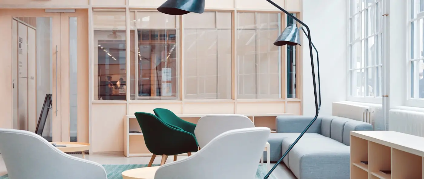 Bright modern office interior with clean desks, chairs, and soft daylight
